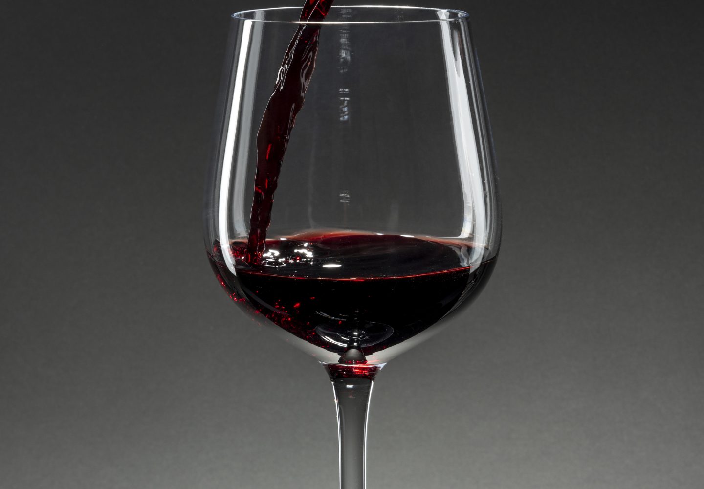 Red wine pouring into a wine glass